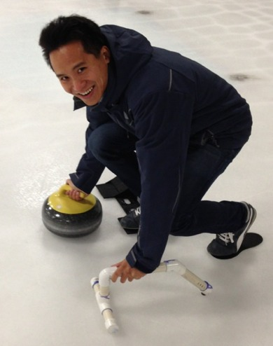 Caltech physicist Clifford Cheung about to throw a curling stone. (Image: Jennifer Ouellette)